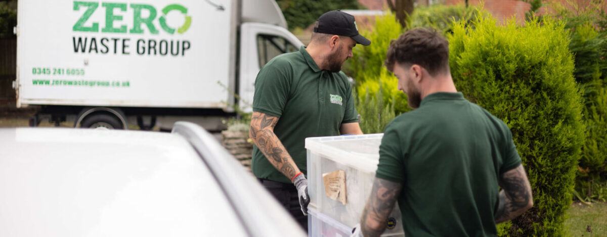 Workers clearing waste in a diffuclt situation during a House Clearance